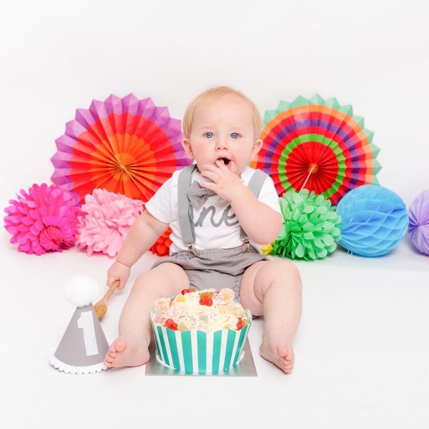 1 year old with cake and colourful pompoms - Cake Smash Photography - Walsall Wolverhampton and West Midlands - Jo Buckley Photography