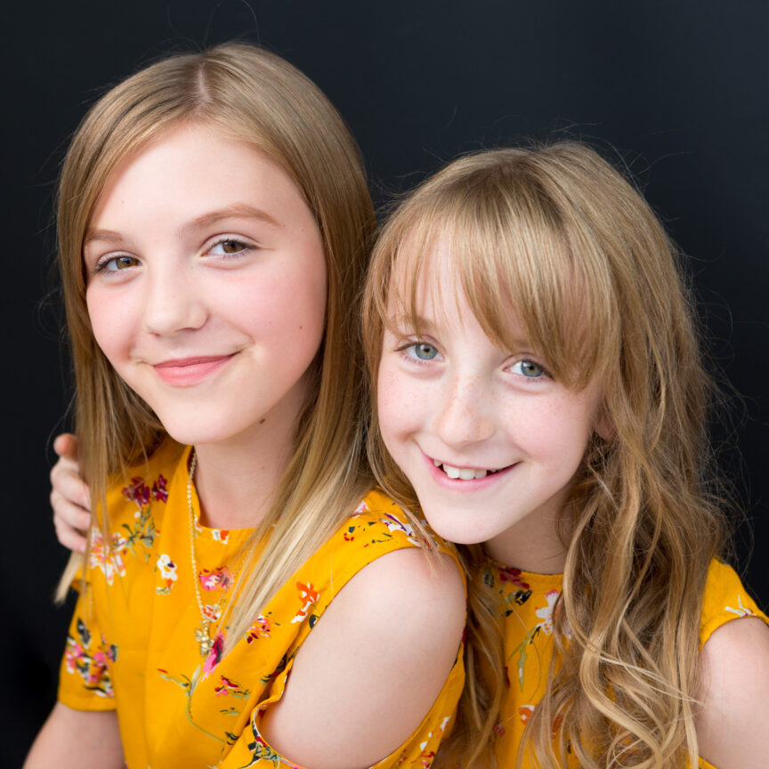 Girls smiling to camera in studio on dark backdrop - Family Photography - Walsall Wolverhampton and West Midlands - Jo Buckley Photography