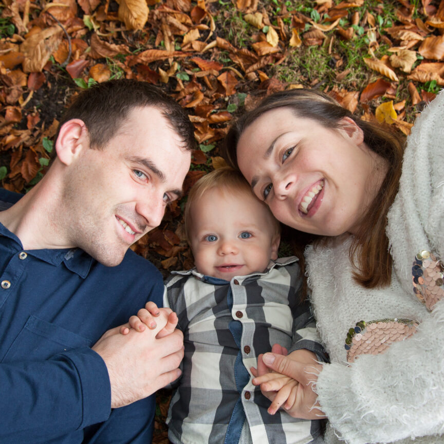 Parents and child laying in leaves looking up to camera - Family Photography - Walsall Wolverhampton and West Midlands - Jo Buckley Photography