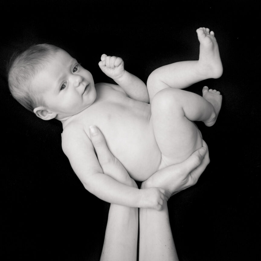 Black and white photo of hands holding baby - Newborn Photography - Walsall Wolverhampton and West Midlands - Jo Buckley Photography