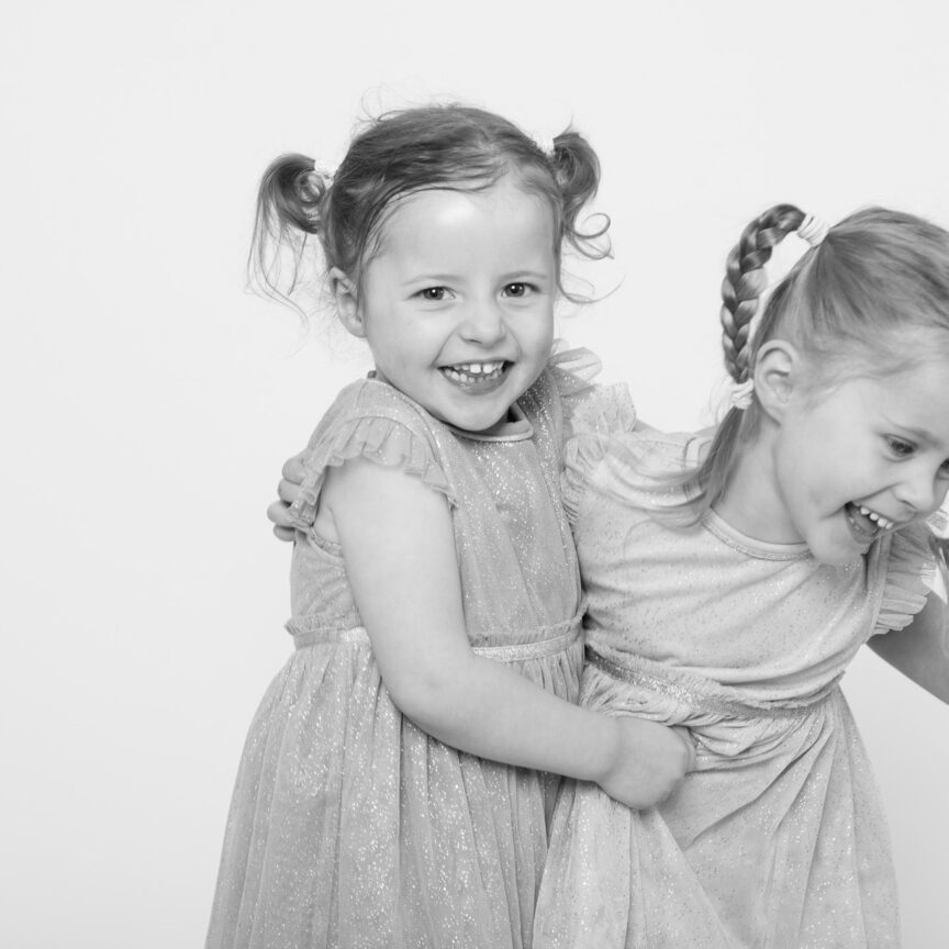 Black and white - two children laughing together - Nursery Playgroup Photography - Walsall Wolverhampton and West Midlands - Jo Buckley Photography