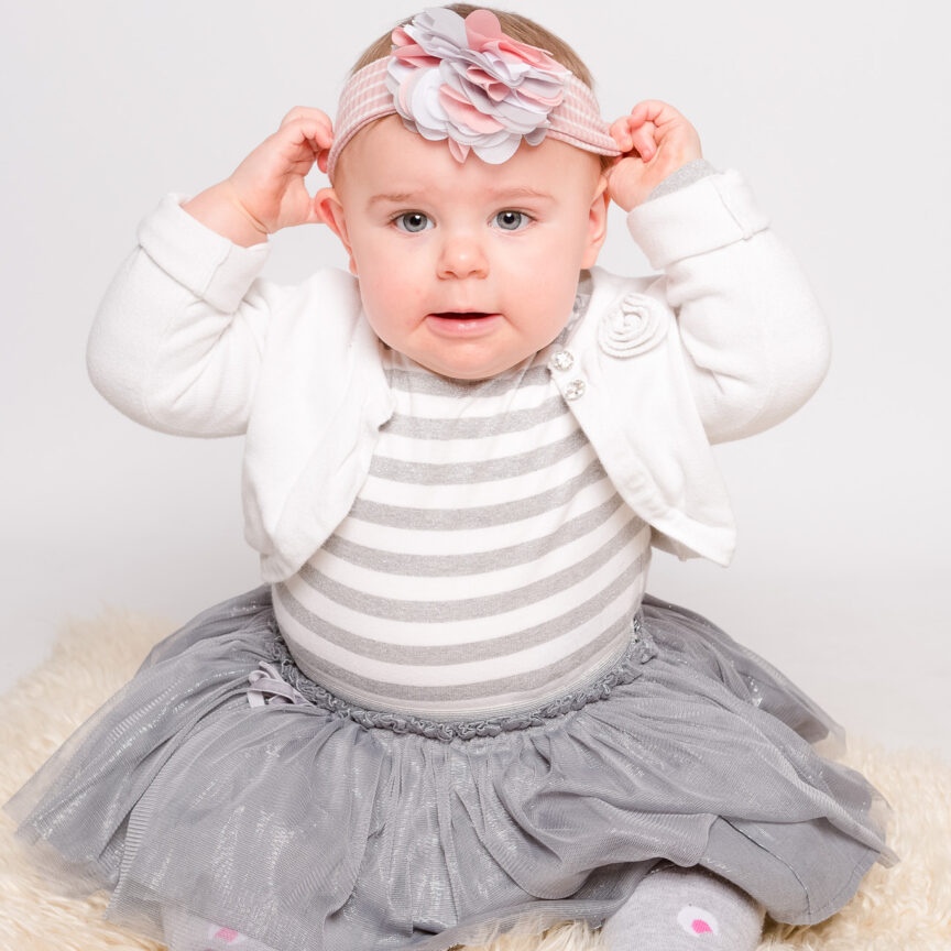 Baby in dress and hairband on white blanket in studio - Sitter Photography - Walsall Wolverhampton and West Midlands - Jo Buckley Photography